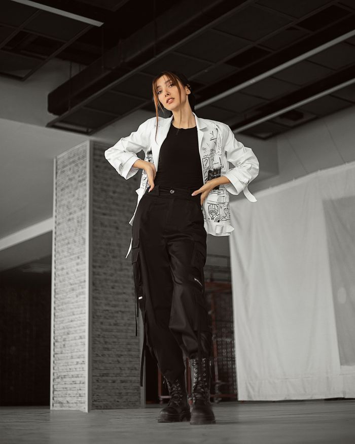 Home Modern style woman in trendy outfit posing inside an urban setting. Chic and confident vibe.