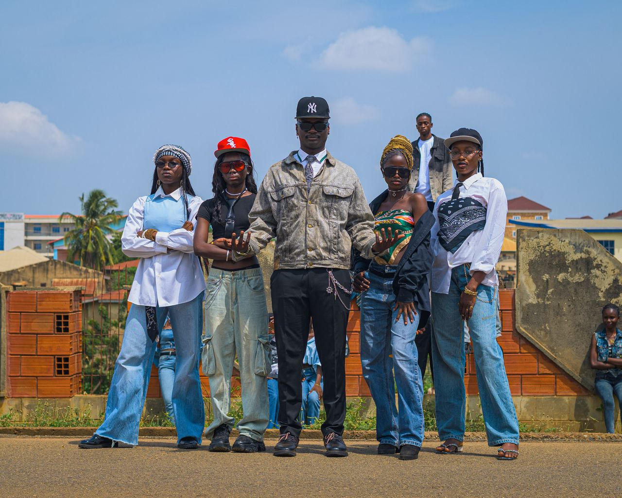 Home Fashionable young adults posing confidently in an urban outdoor environment with casual streetwear.